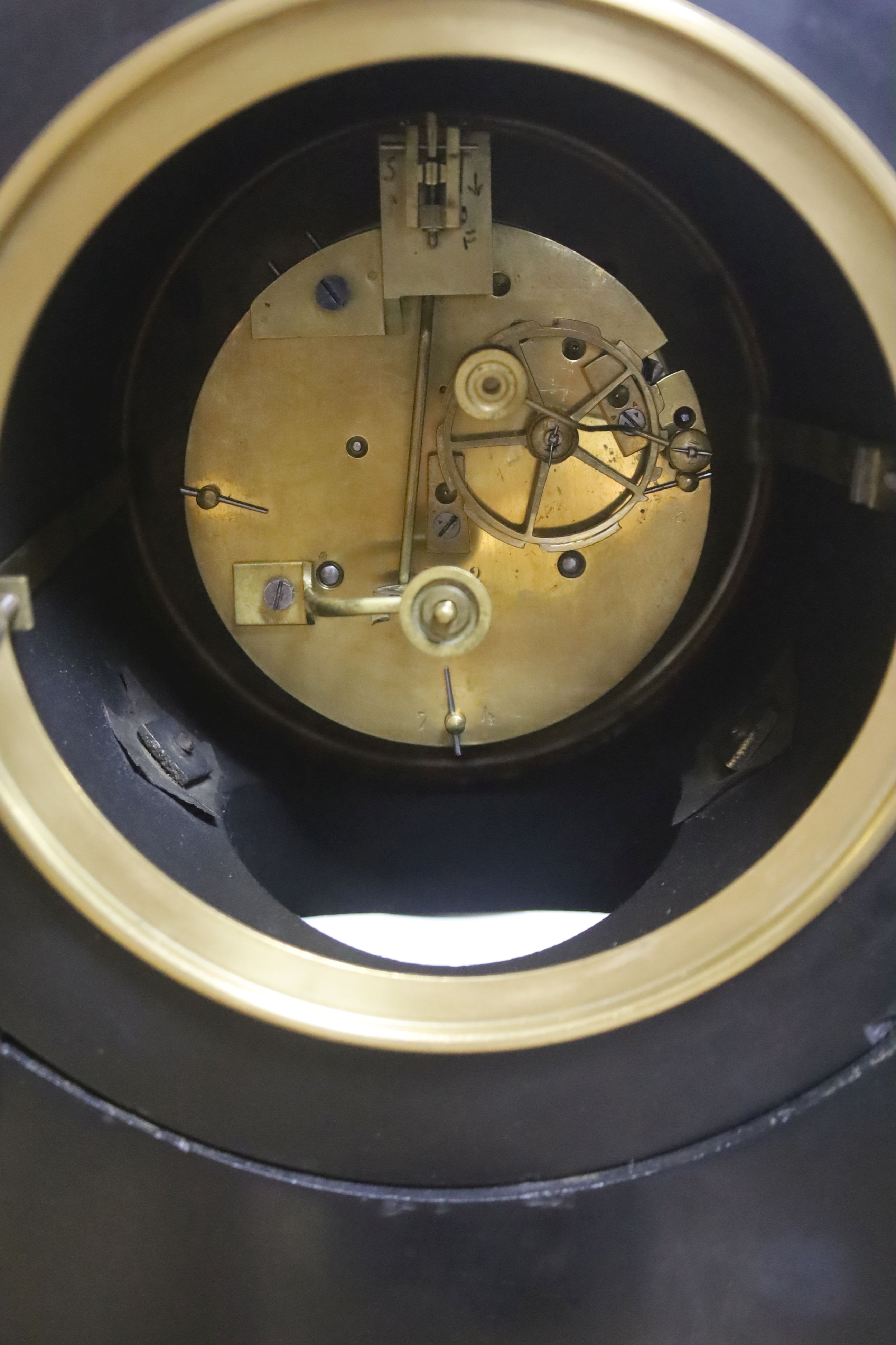 A 19th century Victorian slate clock garniture, the movement with visible Brocot escapement with key and pendulum (af), clock 49cm high